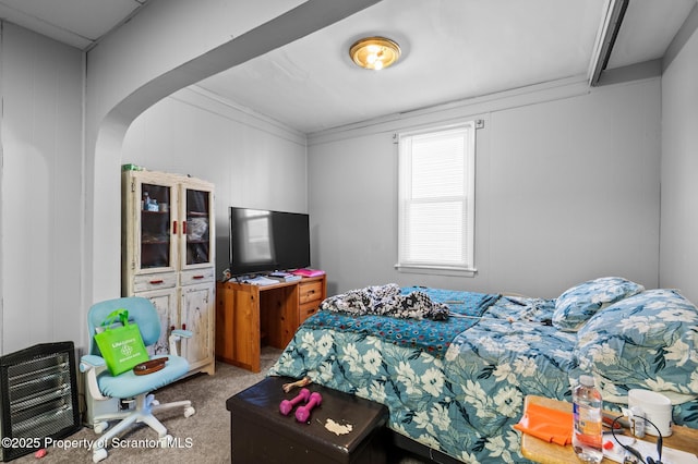 carpeted bedroom with arched walkways