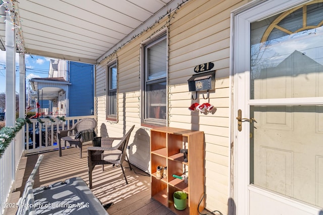 wooden terrace featuring covered porch