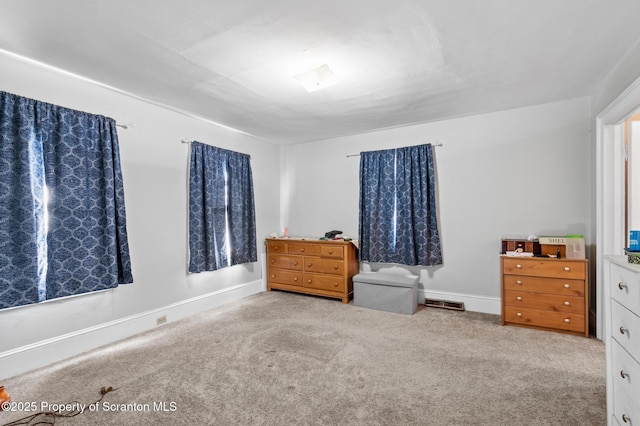 carpeted bedroom with visible vents and baseboards