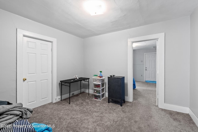 interior space featuring light colored carpet and baseboards