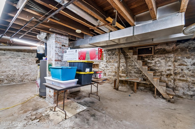 unfinished basement featuring stairway