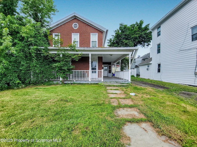 608 E Market St, Scranton, PA 18509 - view of front of house with brick siding, covered porch, and a front lawn