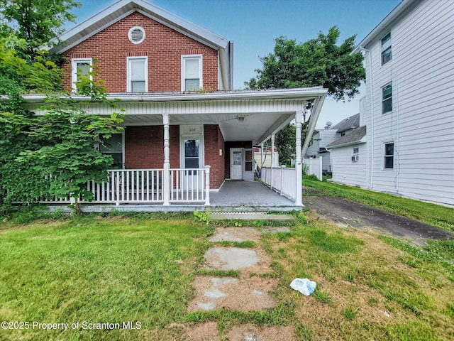 608 E Market St, Scranton, PA 18509 - view of front of property with brick siding, a porch, and a front lawn