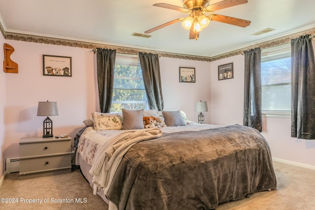 bedroom featuring ceiling fan, light carpet, and multiple windows