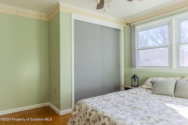 bedroom with a closet, ceiling fan, and hardwood / wood-style flooring