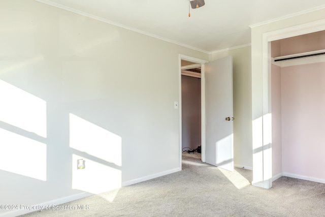 unfurnished bedroom with crown molding, a closet, ceiling fan, and light colored carpet