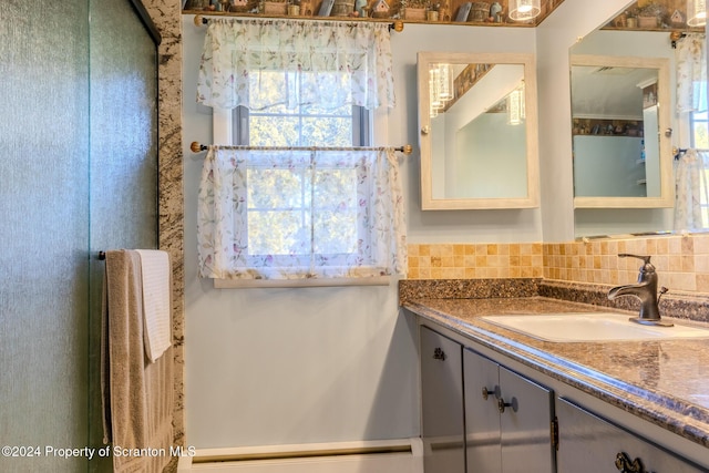 bathroom featuring tasteful backsplash and vanity