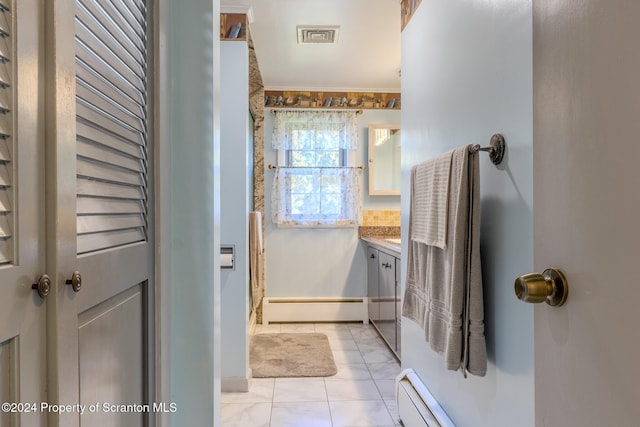 bathroom featuring tile patterned floors, crown molding, vanity, and a baseboard heating unit