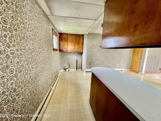 2052 Farr St 2050, Scranton, PA 18504 - kitchen with a paneled ceiling, brown cabinetry, light floors, baseboard heating, and a baseboard radiator