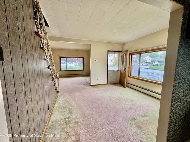 2052 Farr St 2050, Scranton, PA 18504 - spare room featuring baseboard heating, carpet flooring, wood walls, baseboards, and stairs