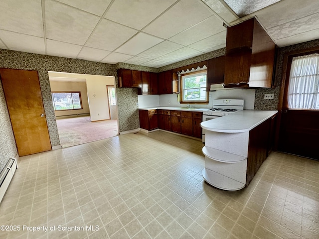 2052 Farr St 2050, Scranton, PA 18504 - kitchen featuring wallpapered walls, light countertops, a peninsula, a paneled ceiling, and under cabinet range hood