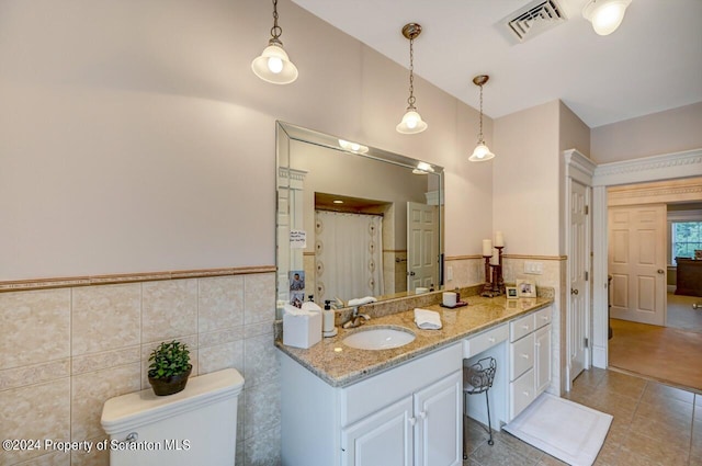 bathroom with tile patterned floors, vanity, tile walls, and a shower with shower curtain