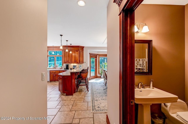 hallway with plenty of natural light and sink