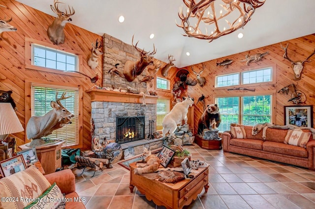 living room with wooden walls, light tile patterned floors, and high vaulted ceiling