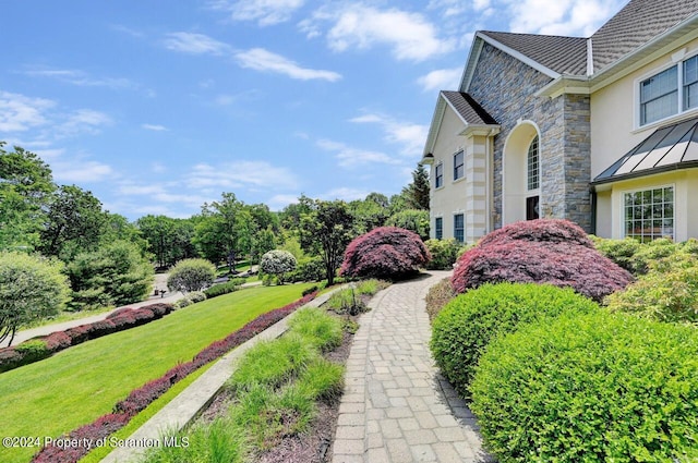 view of side of property featuring a yard