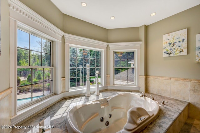 bathroom featuring tiled tub