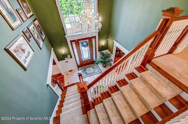 entrance foyer with a towering ceiling and an inviting chandelier