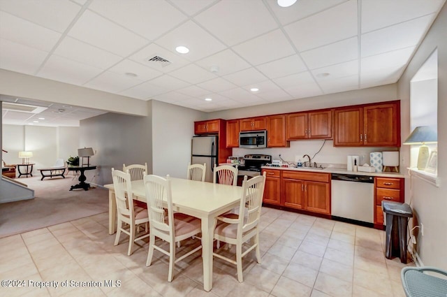 kitchen with a paneled ceiling, sink, and appliances with stainless steel finishes