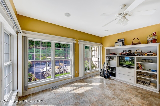 interior space featuring ceiling fan