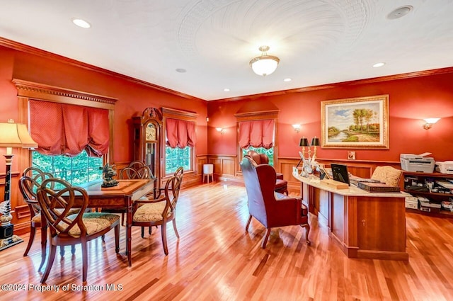 dining space with crown molding and light hardwood / wood-style floors