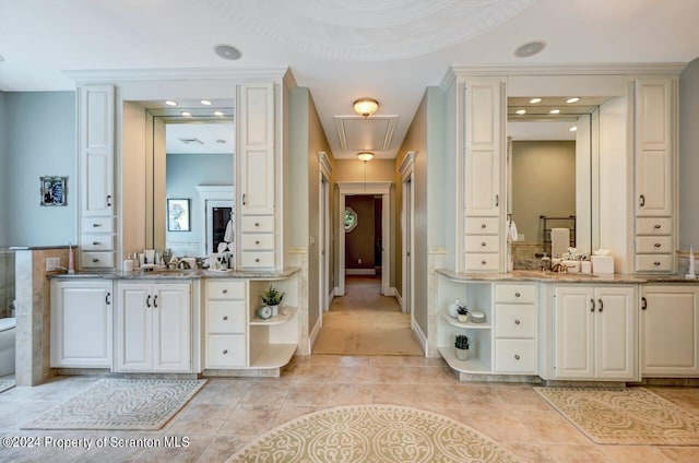 bathroom with tile patterned floors, vanity, and crown molding