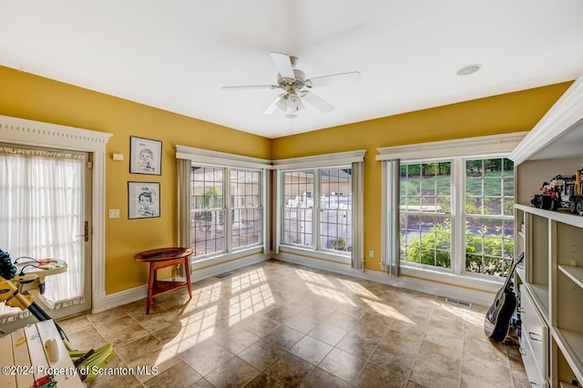 interior space with ceiling fan