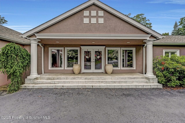 119 Glenmaura Dr, Moosic, PA 18507 - property entrance featuring french doors, a porch, stucco siding, and roof with shingles