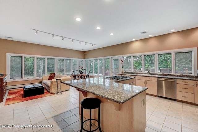 119 Glenmaura Dr, Moosic, PA 18507 - kitchen featuring stainless steel appliances, light brown cabinetry, light tile patterned flooring, dark stone counters, and a breakfast bar