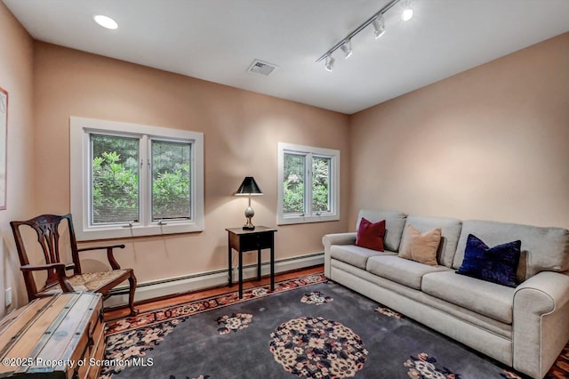 119 Glenmaura Dr, Moosic, PA 18507 - living room with wood finished floors, a baseboard radiator, and rail lighting