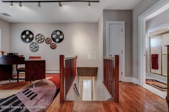 119 Glenmaura Dr, Moosic, PA 18507 - dining space with a baseboard radiator, wood finished floors, and track lighting