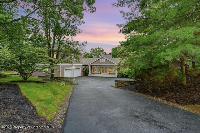 119 Glenmaura Dr, Moosic, PA 18507 - view of front of home featuring driveway, a garage, stucco siding, and a lawn