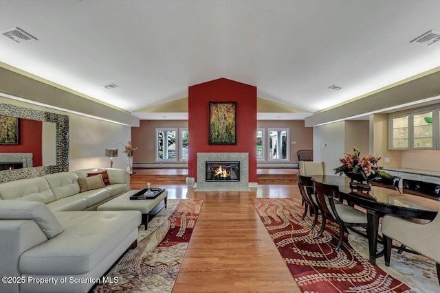 119 Glenmaura Dr, Moosic, PA 18507 - living room featuring a premium fireplace, lofted ceiling, and light wood-style flooring