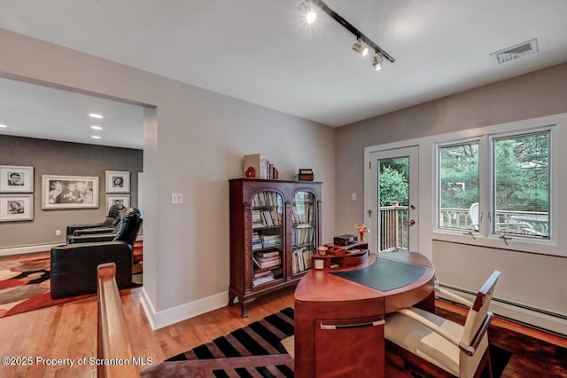119 Glenmaura Dr, Moosic, PA 18507 - office space featuring light wood-type flooring, rail lighting, recessed lighting, baseboard heating, and a baseboard radiator