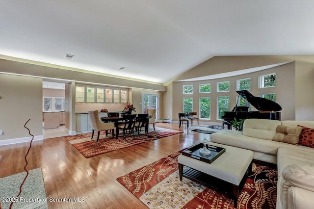 119 Glenmaura Dr, Moosic, PA 18507 - living area with wood finished floors, lofted ceiling, and baseboard heating
