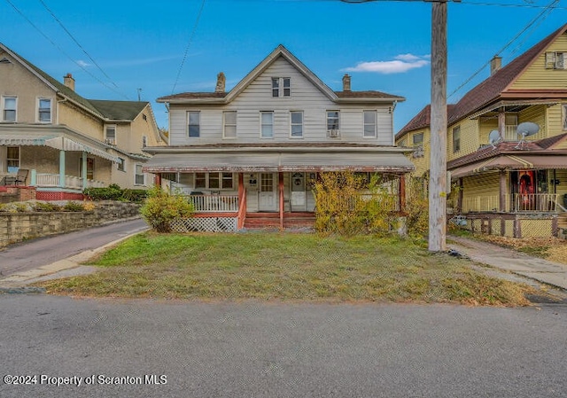 view of front of house with a front lawn and a porch