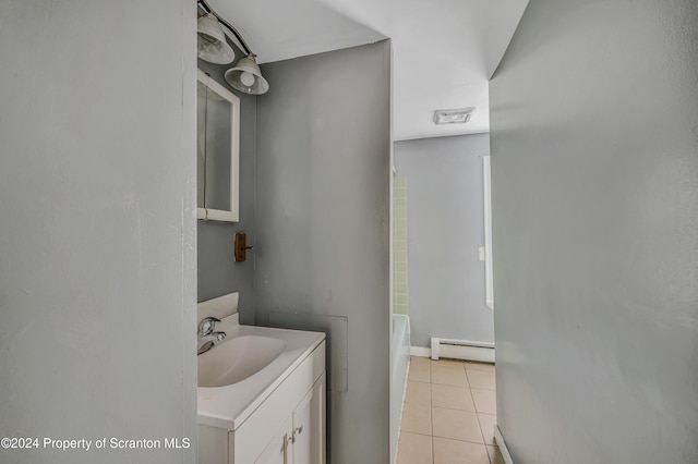 bathroom featuring tile patterned floors, a washtub, vanity, and a baseboard heating unit