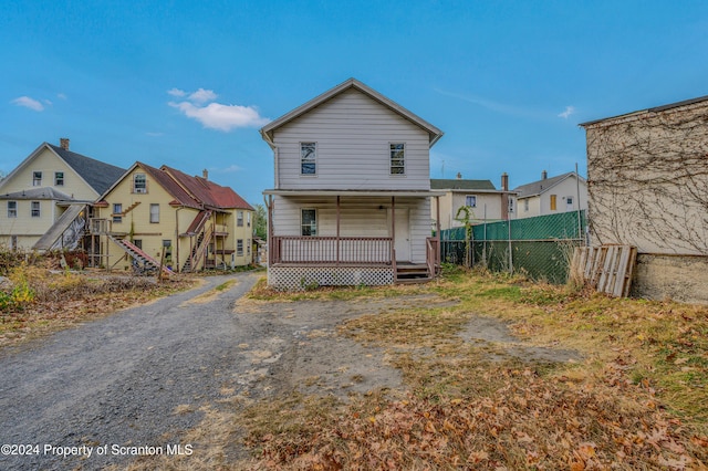 back of property with covered porch