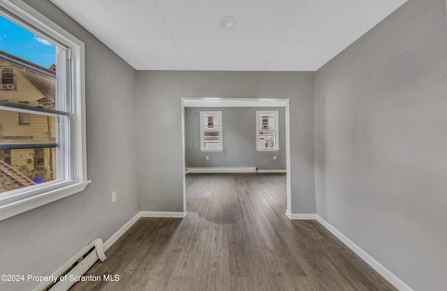 hall with dark hardwood / wood-style flooring and a baseboard radiator