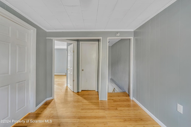 hallway featuring light hardwood / wood-style floors and ornamental molding