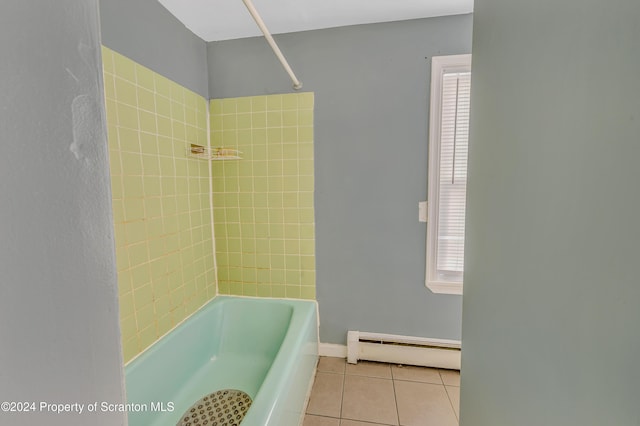 bathroom with tile patterned floors, a healthy amount of sunlight, a baseboard radiator, and tiled shower / bath