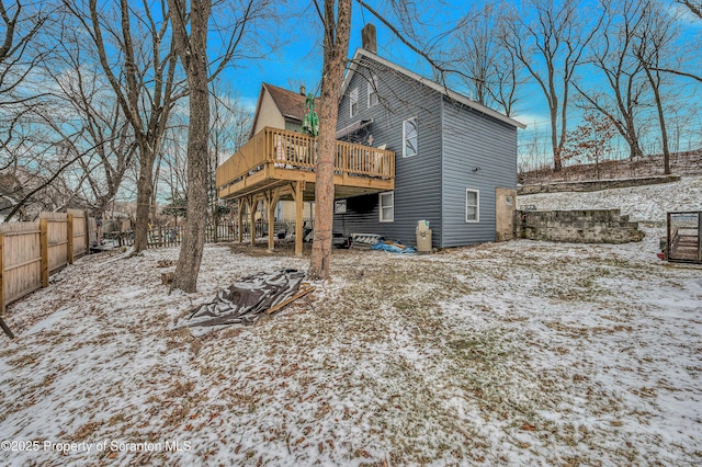 snow covered house with a deck