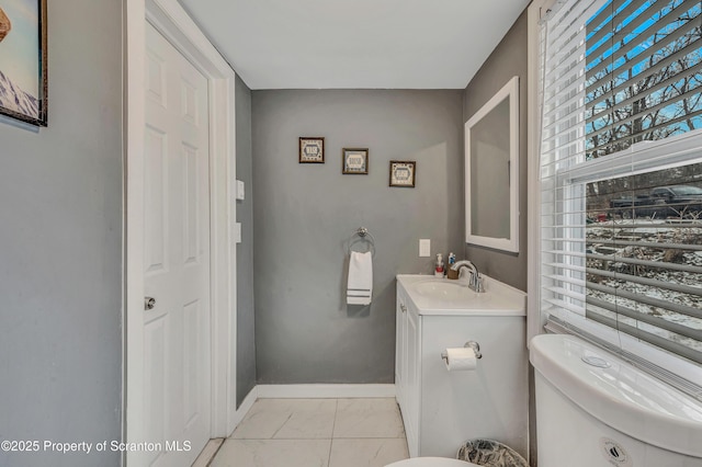 bathroom featuring vanity, tile patterned floors, and toilet