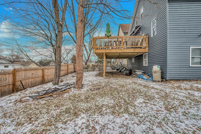 yard layered in snow featuring a wooden deck