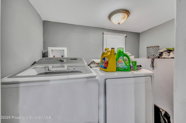 washroom with washing machine and clothes dryer