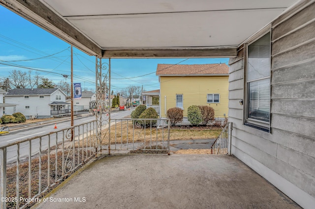 view of patio / terrace with covered porch and a residential view