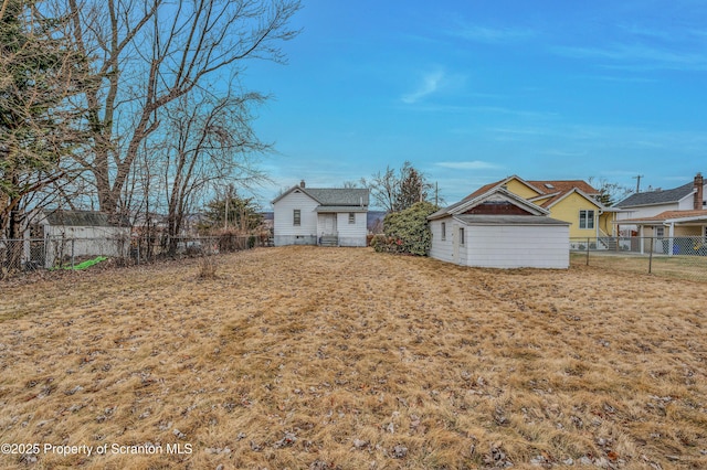 view of yard with an outdoor structure and fence