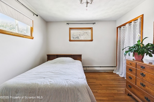 2807 S Webster Ave, Scranton, PA 18505 - bedroom featuring baseboard heating, dark wood-type flooring, and multiple windows