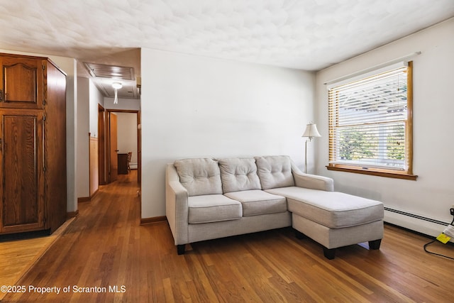 2807 S Webster Ave, Scranton, PA 18505 - living area featuring attic access, light wood finished floors, and a baseboard heating unit