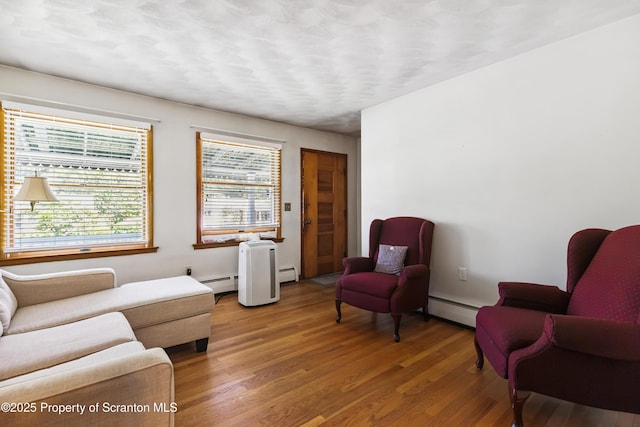 2807 S Webster Ave, Scranton, PA 18505 - living room featuring a baseboard heating unit, wood finished floors, and baseboard heating