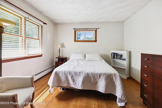 2807 S Webster Ave, Scranton, PA 18505 - bedroom featuring a baseboard heating unit and wood finished floors